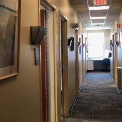 A hallway full of door enterences to offices and exam rooms