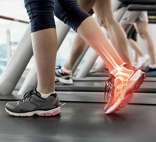 Digital composite of Highlighted ankle of woman on treadmill
